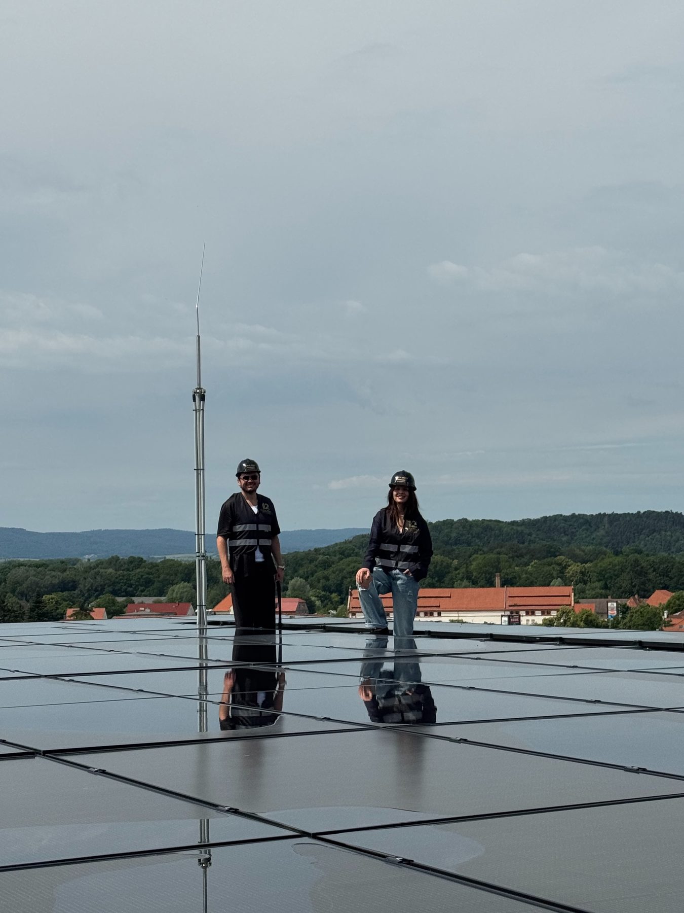 Two of the founders on the roof of the Quedlinburg building, among the photovoltaic array