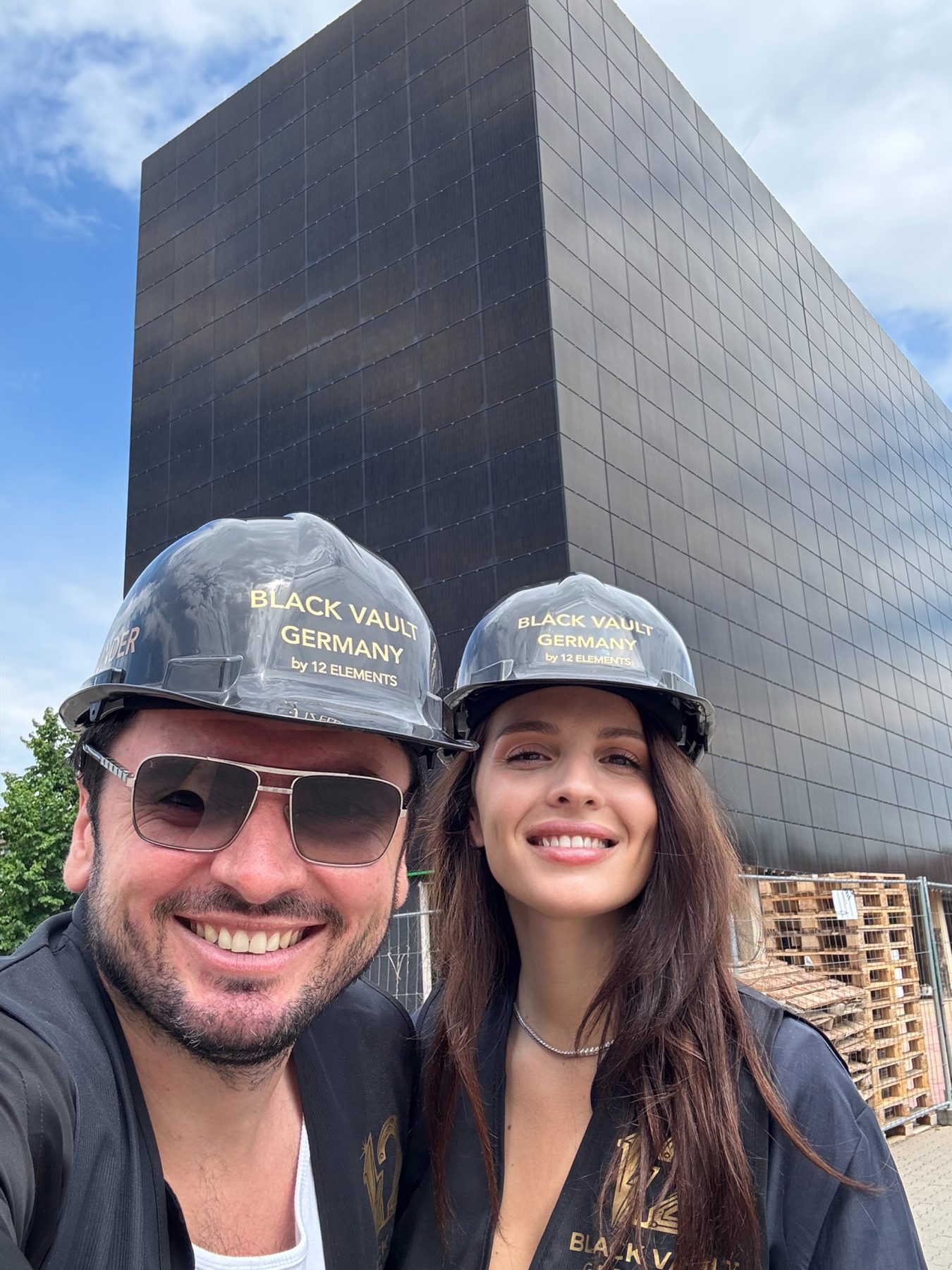 Denys Tsvaig and Anna Bon in Black Vault helmets in front of the photovoltaic-clad Cube in Quedlinburg